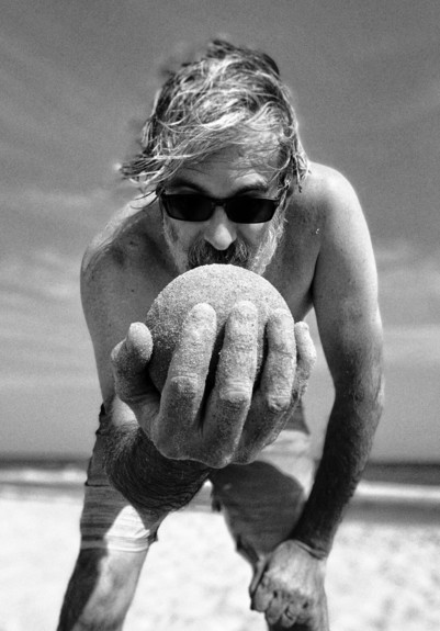 me with black sunglasses on the beach presenting one of my most perfect sandballs.