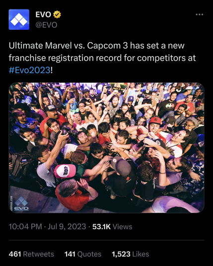 Screenshot of a tweet from @EVO announcing a new franchise registration record for Ultimate Marvel vs Capcom 3 at EVO 2023. Beneath, a picture of a crowd of fans mobbing a victorious competitor.