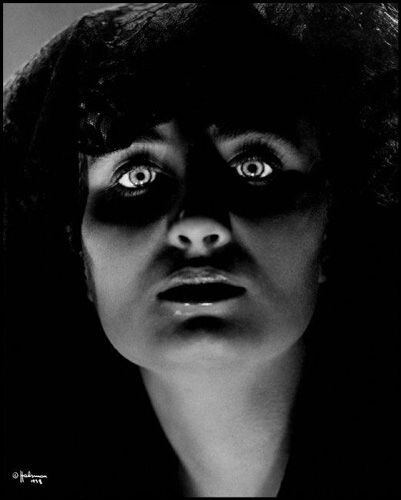 woman with piercing eyes in shadows