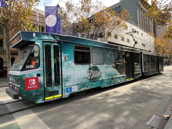 Tram on Melbourne street decorated all over with promotional artwork for 'The Legend of Zelda: Tears of the Kingdom'.