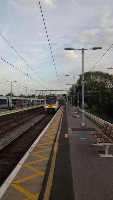 Wickford Station, looking along the London-bound platform in the direction of Essex, from whence an electric train approaches.
Across the tracks, on the Essex-bound platform, another train waits, having just offloaded a crowd of day-trippers (including me).
For some reason, the lights have been switched on over the Essex-bound platform, but not on the one I was standing on. I could have asked why, but I had a train to catch.