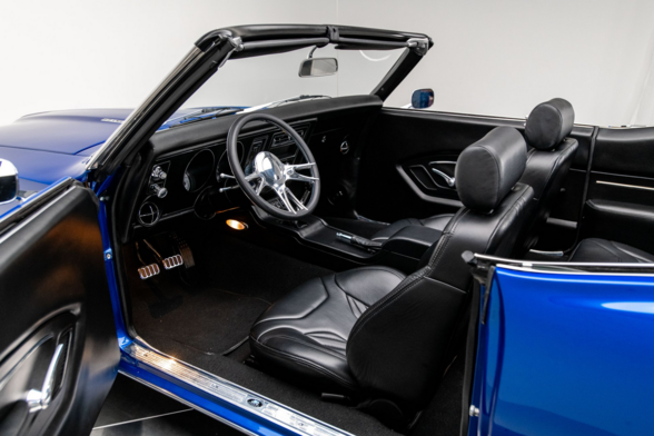 the door is open , the interior is all black leather with some silver